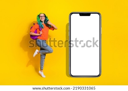 Full length body size view of beautiful trendy cheerful girl jumping showing thumbup ad isolated over bright yellow color background