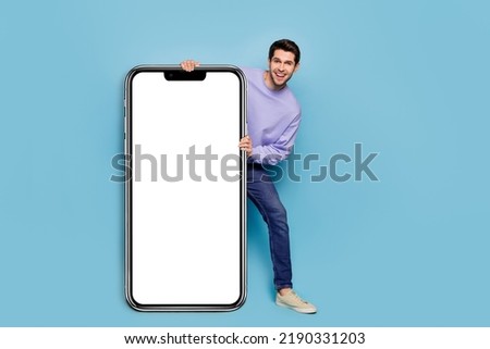Full body photo of cheerful funny guy demonstrate empty space blank offer isolated on blue color background