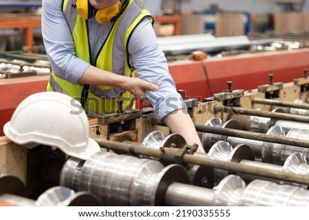 Engineer Worker Hand Got Trapped in the Industrial Machine and Got Crush Injury Royalty-Free Stock Photo #2190335555