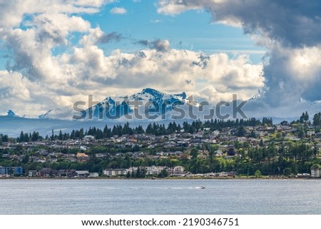 City of Campbell River with Golden Hinde mountains behind taken from Discovery Passage on cruise ship Royalty-Free Stock Photo #2190346751