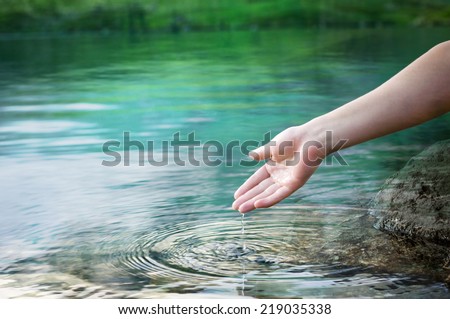 water dropping from a hand Royalty-Free Stock Photo #219035338