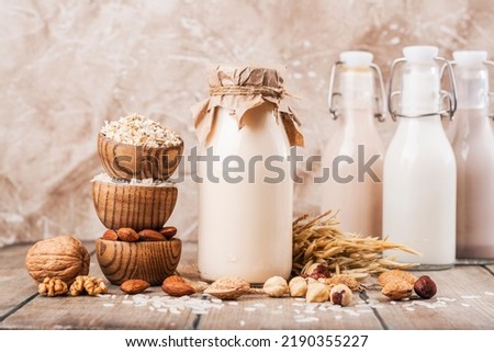 Plant based, lactose free milk. Homemade lactotse-free milk with ingredients on wooden background. World plant milk day. Copy space Royalty-Free Stock Photo #2190355227
