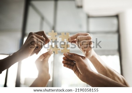 Business people hands with puzzle showing solution, problem solving and teamwork. Smart group or team activity completing, finishing a task project or assignment in difficult challenging work crisis Royalty-Free Stock Photo #2190358155