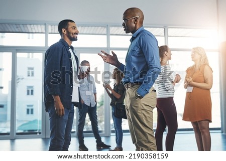 Creative men talking at networking event, sharing startup ideas and discussing new innovation at business conference. Diverse group of people meeting, collaborating or having a conversation in Royalty-Free Stock Photo #2190358159
