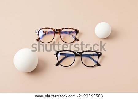Stylish eyeglasses over pastel background. Optical store, glasses selection, eye test, vision examination at optician, fashion accessories concept. Top view, flat lay Royalty-Free Stock Photo #2190365503