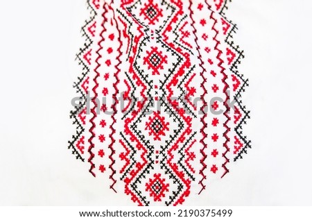 Defocus emboidery ukrainian pattern background. Ukrainian ornament. Ornaments embroidered on clothes. Ukraine embroidered on a white background. Out of focus.