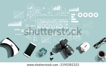 Micropayments theme with electronic gadgets and office supplies - flat lay Royalty-Free Stock Photo #2190382323