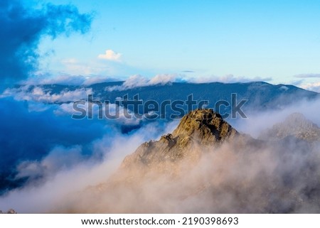 Clouds hovering around the surrounding peaks