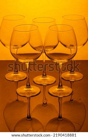 Still life with empty wine glasses on a reflective surface