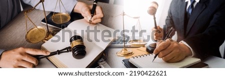 Justice and law concept. Gavel on sounding block in hand's Male judge at a courtroom, working with document law books, report the case on table in modern office.