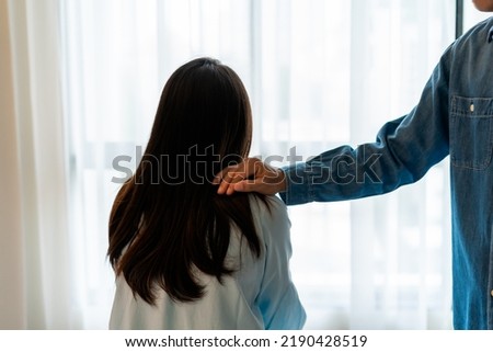 Young man comforting and supporting a sad woman who is in serious trouble at home, Consolation and encouragement concept Royalty-Free Stock Photo #2190428519