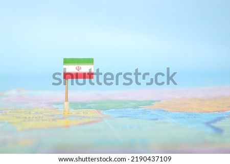 Selective focus of Iranian flag in world map. Iran country location and sovereignty concept. Royalty-Free Stock Photo #2190437109