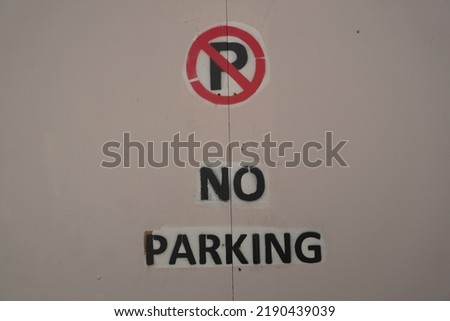No parking stencil sign on wooden gate