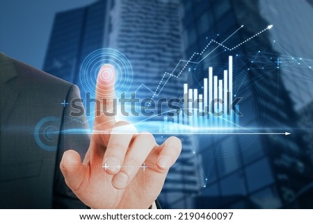 Close up of businessman hand pointing at abstract glowing polygonal business graph hologram with growing arrow on blurry city background. Financial growth, market and trade concept