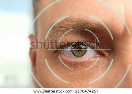 Closeup view of man and mark illustration on his eye. Vision correction surgery Royalty-Free Stock Photo #2190474267