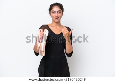 Young caucasian woman practicing ballet isolated on white background inviting to come with hand. Happy that you came