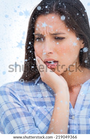 Composite image of Close up of brunette looking something with snow falling