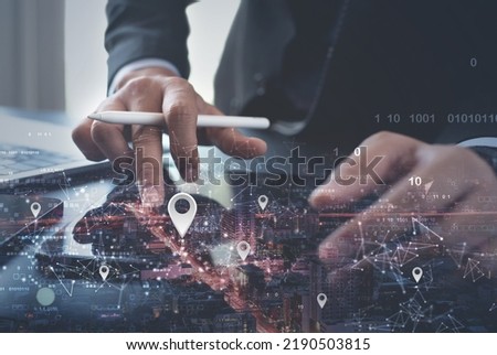 GPS map, pin address location on mobile apps. Double exposure of man hand using digital tablet searching target place on cityscape, smart logistic, global business technology concept Royalty-Free Stock Photo #2190503815
