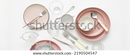 Set of stylish dinnerware and cutlery on white background, top view Royalty-Free Stock Photo #2190504547