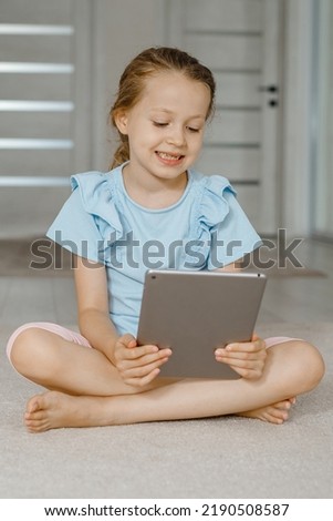 Child and electronic devices concept. Portrait of toddler with smartphone.little child girl using digital tablet at home. kid using gadgets for learning.