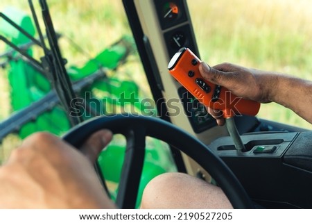 closeup view of farmer's hands driving combine harvester, tractor operating controlling machinery. High quality photo