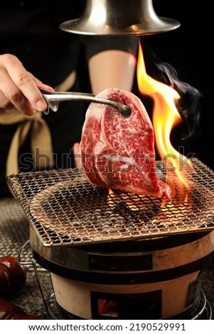 Japanese barbecue, Barbecue grill burning , Japanese buffet restaurant. snowflakes and beef,Kobe beef
