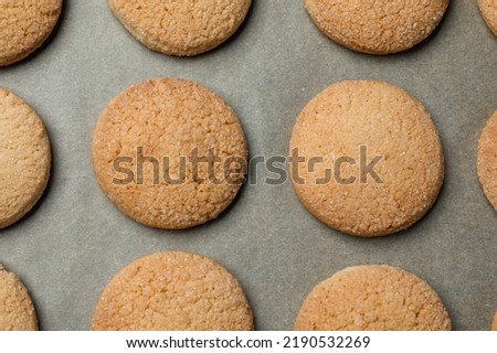 Delicious sugar cookies on parchment paper, flat lay Royalty-Free Stock Photo #2190532269