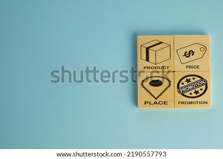 4P Marketing Mix for business concept.4P marketing mix icon and text on wooden cube over blue background with copyspace for put text or logo.