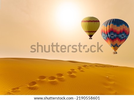 Desert and hot air balloon Landscape at Sunrise. Travel, inspiration, success, dream, flight concept Royalty-Free Stock Photo #2190558601