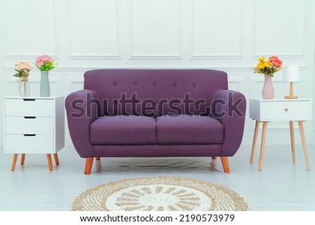 Room decoration with purple chairs and nightstands on the right and left and a white molding wall background. Photo studio property decoration.