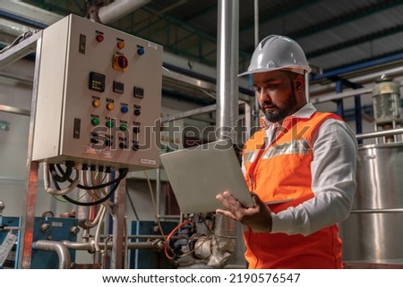 Electrical Mechanical Electronic Plant Engineer Indians in charge of monitoring and maintaining the factory work system to keep it working there is no system disruption in production plant Royalty-Free Stock Photo #2190576547
