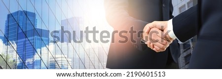 Double exposure of handshake between businessman with cityscape on background - Business success agreement, Immovable property concept. panoramic banner