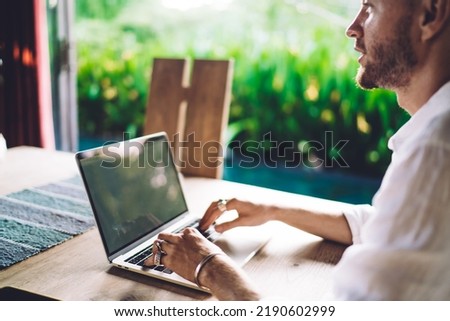 Pondering male IT professional with modern laptop computer thinking about idea for creating graphic design, contemplative Caucasian man with digital netbook technology thoughtful looking away
