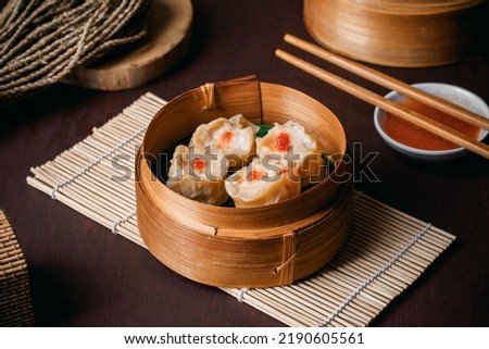 chicken dimsum served in bamboo plate Royalty-Free Stock Photo #2190605561