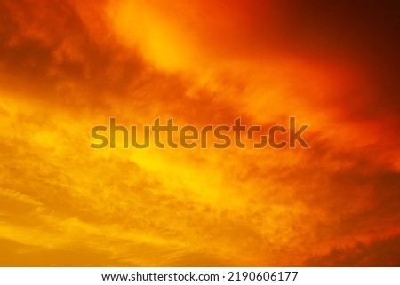  Yellow orange red sunset. Dramatic sky with storm clouds. Colorful sky background with space for design. Bright, fire, glow, explosion, light.                              