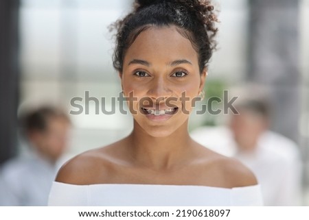 a business woman smiling inside office building