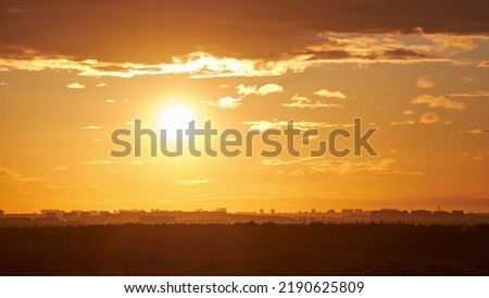 Evening sky with setting sun through clouds at sunset, cloudy landscape