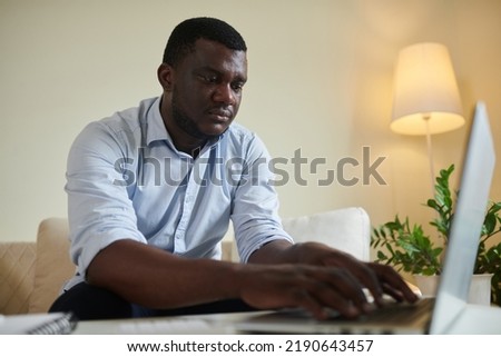 Stressed man paying credit card debt and utility bills online