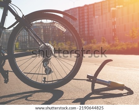 Inflating bike tire outdoors. Pumping up bicycle tyre. Closeup

