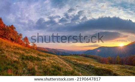 Beautiful sunset in the mountains, picturesque landscape in a mountain valley. The sun goes down behind the mountain range. Golden autumn in the Ukrainian Carpathians Royalty-Free Stock Photo #2190647817