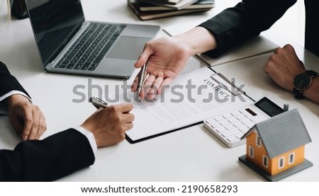 Real estate broker agent consult to customer to decision making sign insurance form and sending house model to client after approve, home model mortgage loan offer for and house insurance
