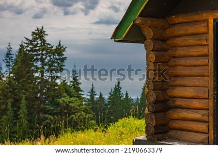 Old wooden hut cabin in mountain alps at rural summer landscape. Cozy wooden cabin in a forest. Tourist hikers summer accommodation in the mountains. Beautiful British Columbia, Canada. Travel photo