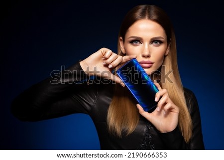 Beautiful woman handling phon. Bright makeup and beautiful hairstyle Royalty-Free Stock Photo #2190666353