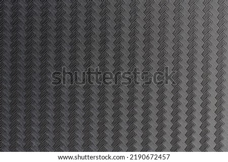 Clean carbon fiber background. Composite grid surface close up view