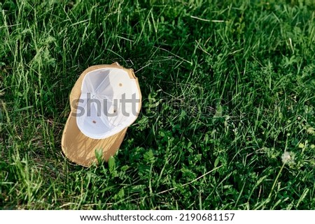 The sports cap lies on the fresh green grass