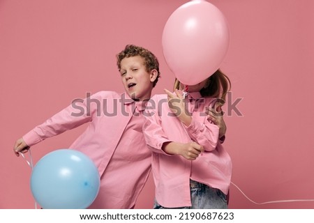 cute, beautiful children, brother and sister, joyfully play with inflatable balloons