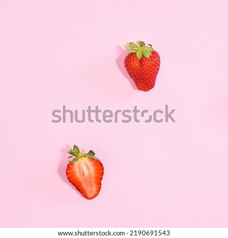 Delicious red strawberries fruits on pastel pink background. Flat lay