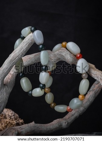 Colorful beads made of natural semiprecious stones on a white background. Isolated jewelry close up. Stone texture, energy mineral, beaded necklaces, rock.