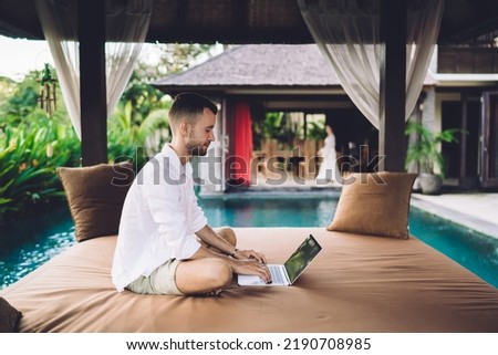 Caucasian software developer working remotely on modern laptop technology using media application for creating web design, skilled male freelancer with digital netbook browsing online video