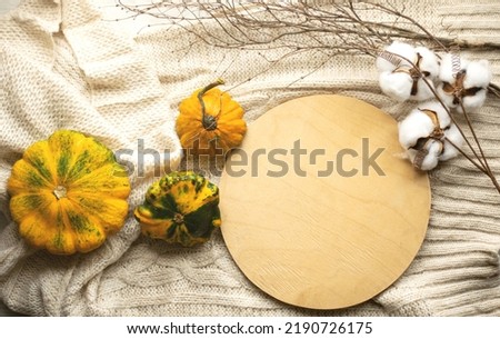 Autumn still life with pumpkins on the table, top view. Visual picture.